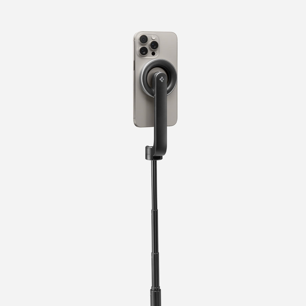 AMP07659 - Tripod Selfie Stick (Mag Fit) | S580W in Black showing the back of an iPhone attached magnetically to the S580W selfie stick via the MagFit mount, with the stick fully extended against a light gray background.