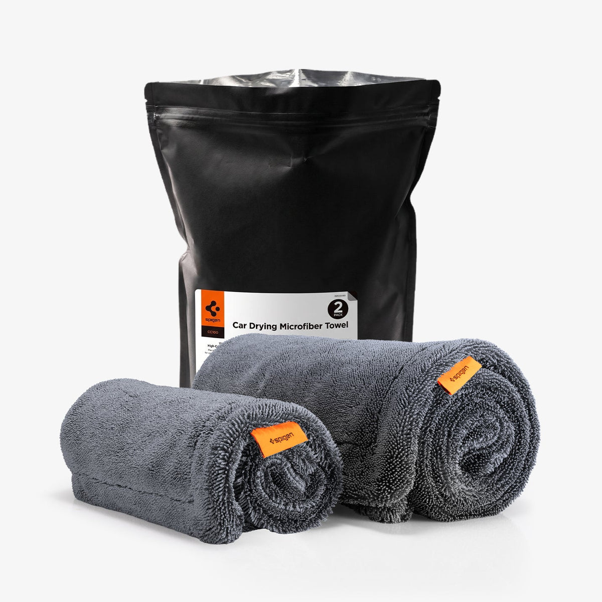 ACP11389 - Spigen CC100 Car Drying Microfiber Towel 2-pack packaging bag next to two rolled gray towels with orange tags