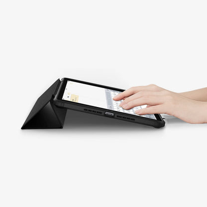 ACS03906 - iPad 10.2" Case Ultra Hybrid Pro in black showing the bottom and front with device propped up by built in kickstand and hands typing on screen