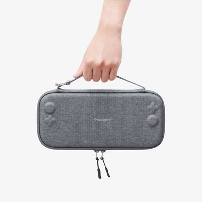 AGP10197 - Nintendo Switch 2 Klasden Pouch 2 in Charcoal Gray showing a person holding the pouch by the strap