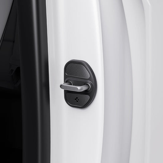 ACP07123 - Tesla Model Y & 3 Door Lock Cover TO320 in Black showing the hand of a man attaching the the lock cover to the door striker hook