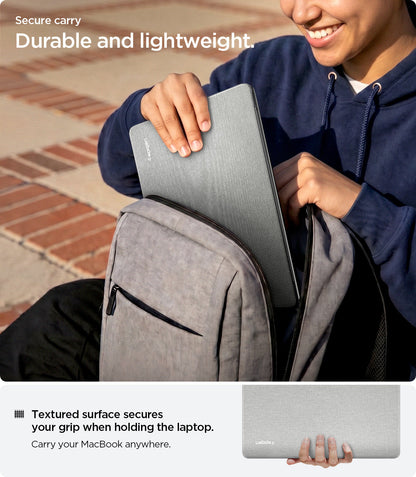 ACS10975 - MacBook Air 15-inch in Heather Gray showing lifestyle shot of inserting MacBook into backpack; highlights durable and lightweight build with textured surface for secure grip