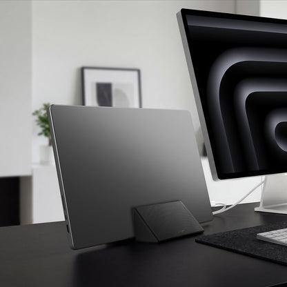 AMP11118 - Slim Fold Laptop Stand | Non-Adhesive | Black LD201-S9 showing MacBook laptop vertically mount to the laptop stand for storage